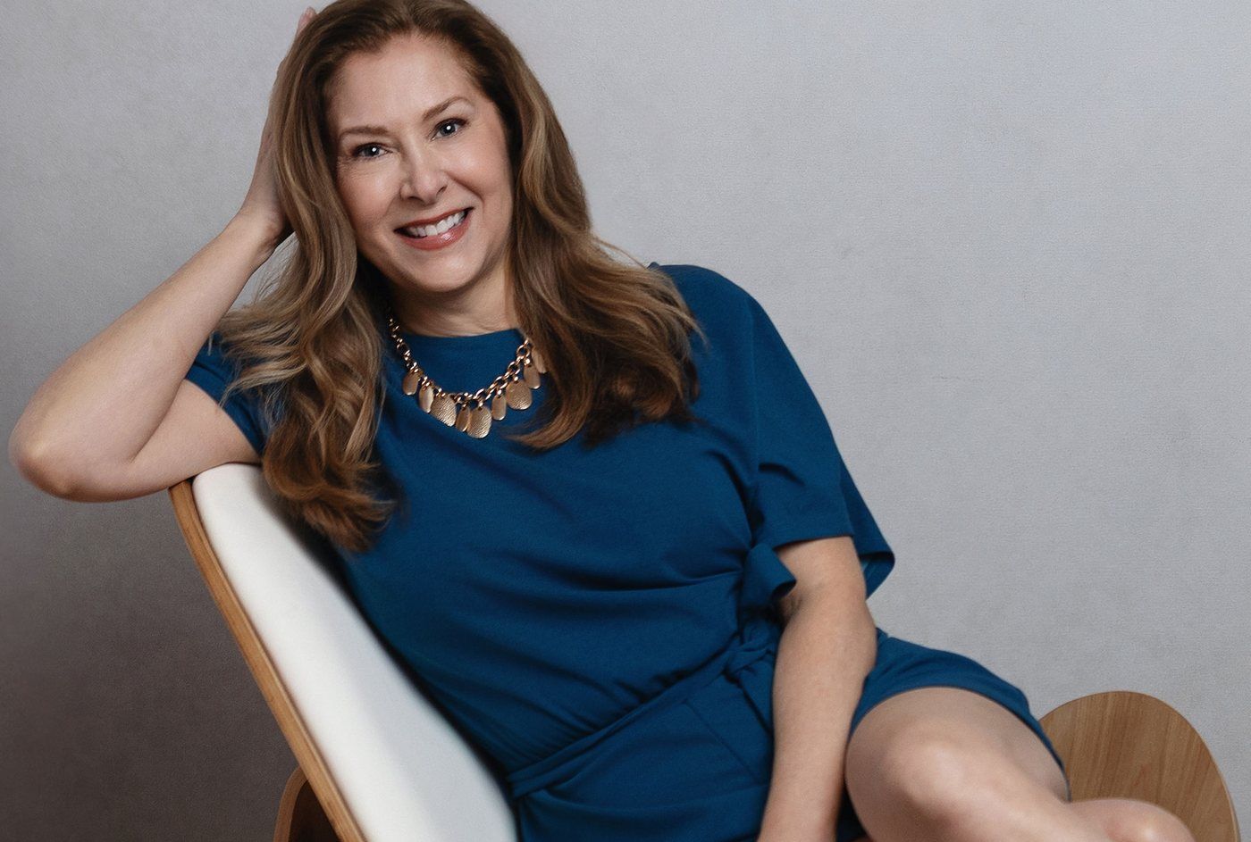 Vanessa Allen smiling in a white lounge chair